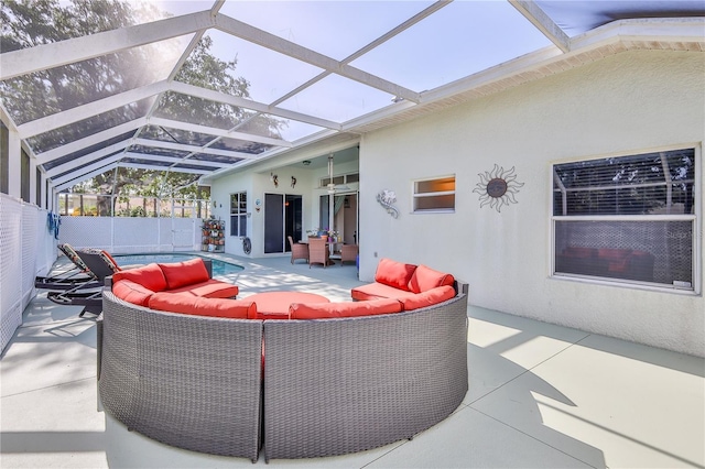 view of patio / terrace featuring an outdoor living space and glass enclosure