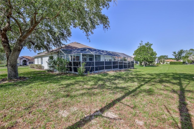 view of green lawn featuring a lanai