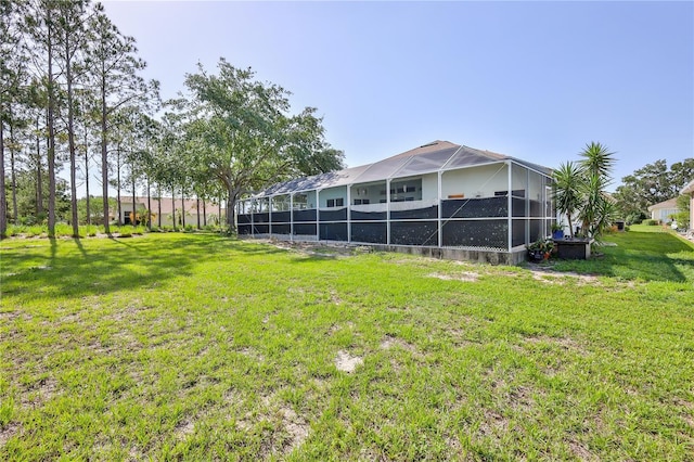 view of grassy yard featuring a lanai