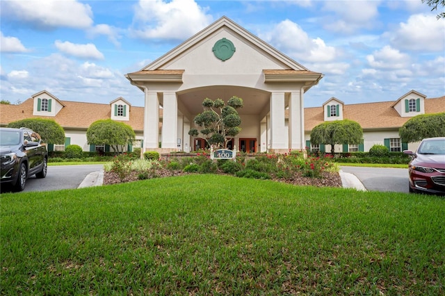 view of front of house featuring a front lawn and stucco siding