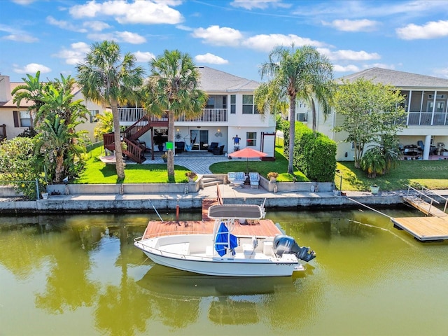 4292 Tahiti Dr, Hernando Beach, FL 34607 - dock with a water view, a patio, stairs, and a lawn