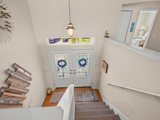 4292 Tahiti Dr, Hernando Beach, FL 34607 - foyer featuring stairs, wood finished floors, french doors, and a high ceiling