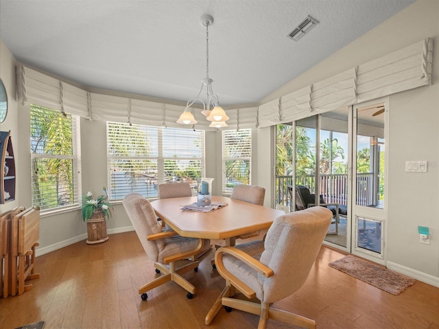 4292 Tahiti Dr, Hernando Beach, FL 34607 - dining space with baseboards, wood finished floors, and a textured ceiling