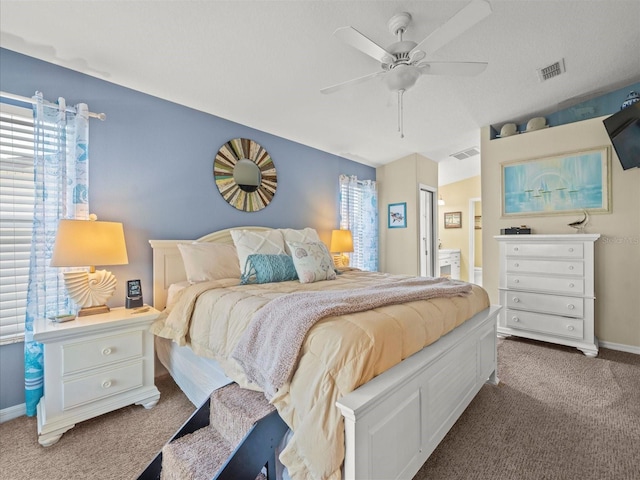 4292 Tahiti Dr, Hernando Beach, FL 34607 - carpeted bedroom featuring multiple windows, connected bathroom, ceiling fan, and baseboards