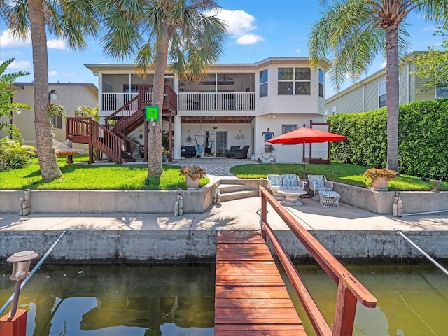 4292 Tahiti Dr, Hernando Beach, FL 34607 - dock area featuring a patio area, stairs, a water view, and a yard