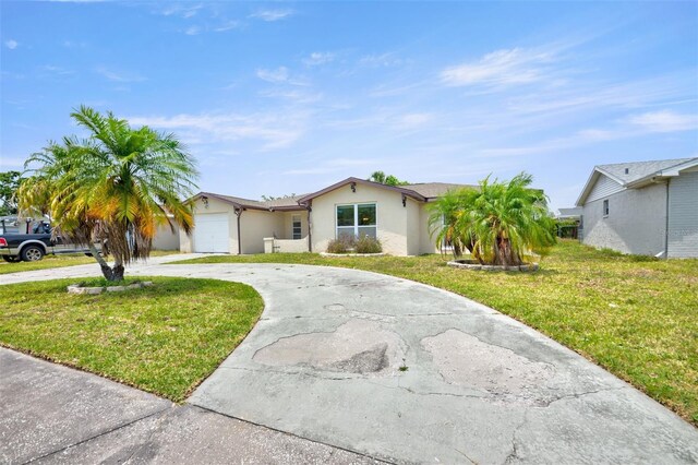 6231 Westport Dr, Port Richey, FL 34668 - ranch-style house featuring curved driveway, a garage, stucco siding, and a front yard