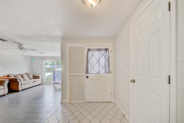 6231 Westport Dr, Port Richey, FL 34668 - foyer entrance with a textured ceiling, a ceiling fan, light tile patterned flooring, and baseboards