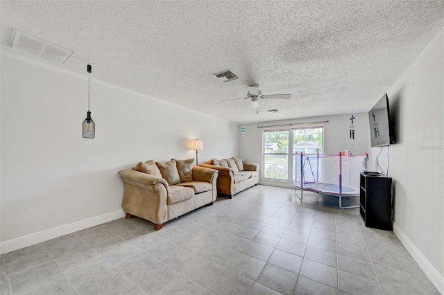 6231 Westport Dr, Port Richey, FL 34668 - living area featuring a textured ceiling, a ceiling fan, light tile patterned floors, and baseboards