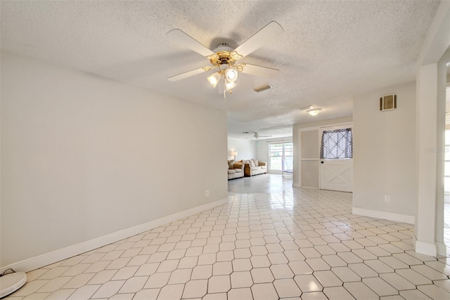 6231 Westport Dr, Port Richey, FL 34668 - spare room with a ceiling fan, a textured ceiling, and baseboards