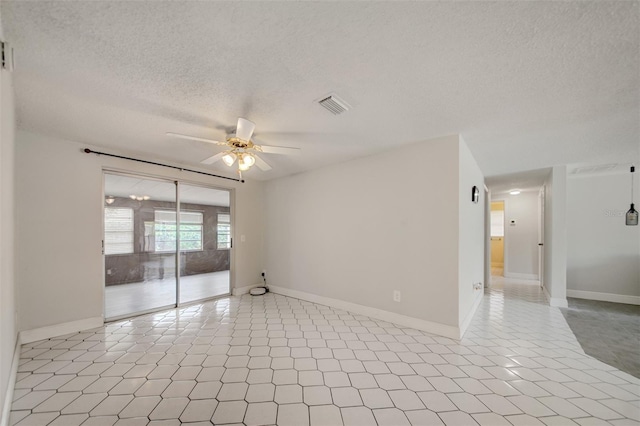 6231 Westport Dr, Port Richey, FL 34668 - unfurnished room featuring ceiling fan, a textured ceiling, baseboards, and light tile patterned floors