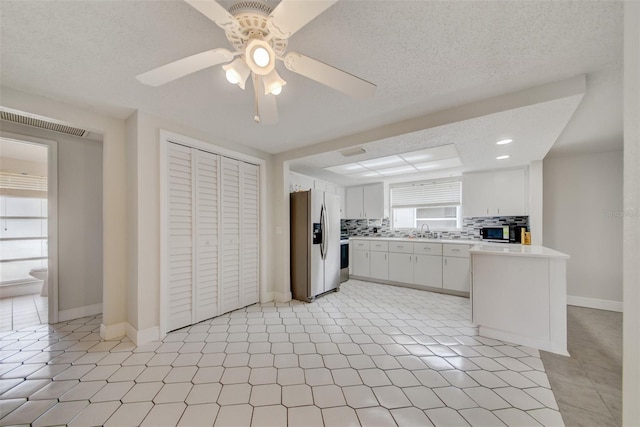 6231 Westport Dr, Port Richey, FL 34668 - kitchen with stainless steel refrigerator with ice dispenser, ceiling fan, light countertops, backsplash, and a sink