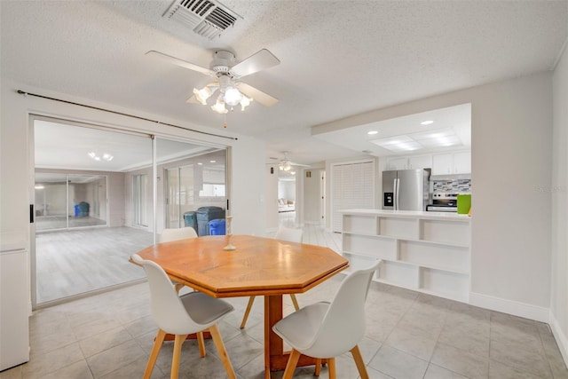 6231 Westport Dr, Port Richey, FL 34668 - dining area with a ceiling fan, a textured ceiling, light tile patterned flooring, baseboards, and recessed lighting