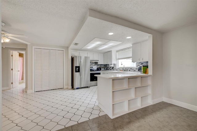 6231 Westport Dr, Port Richey, FL 34668 - kitchen featuring stainless steel appliances, a textured ceiling, open shelves, ceiling fan, and light countertops