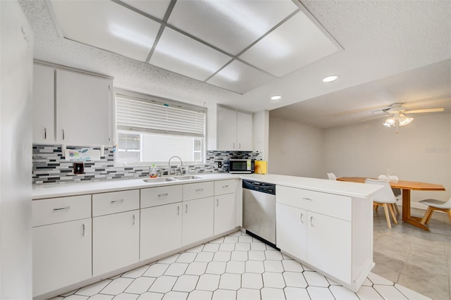 6231 Westport Dr, Port Richey, FL 34668 - kitchen with a sink, appliances with stainless steel finishes, a peninsula, tasteful backsplash, and recessed lighting