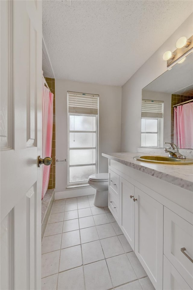 6231 Westport Dr, Port Richey, FL 34668 - full bath featuring tile patterned floors, a textured ceiling, toilet, vanity, and a shower with shower curtain