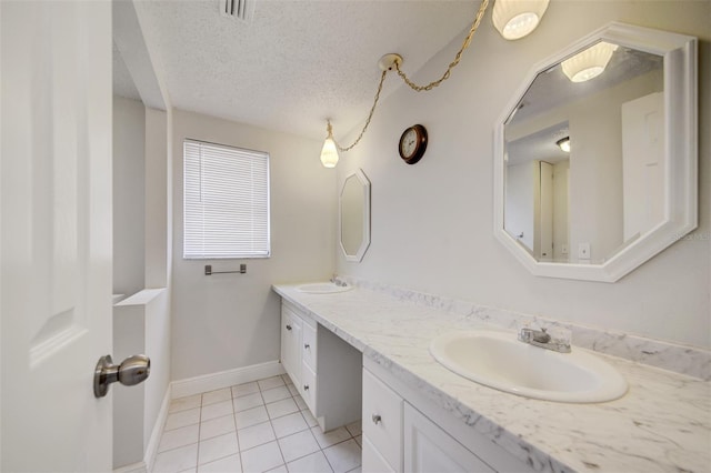 6231 Westport Dr, Port Richey, FL 34668 - bathroom with tile patterned floors, a textured ceiling, baseboards, and double vanity