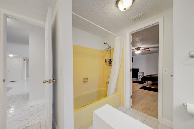 6231 Westport Dr, Port Richey, FL 34668 - full bathroom featuring tile patterned flooring, a textured ceiling, shower / bath combination with curtain, baseboards, and a ceiling fan