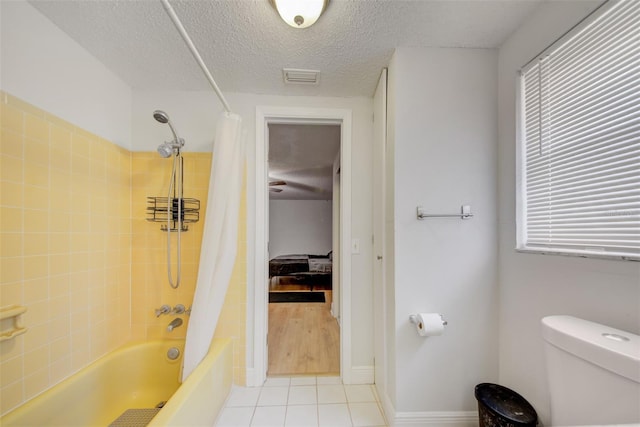 6231 Westport Dr, Port Richey, FL 34668 - full bath with toilet, shower / tub combo, a textured ceiling, tile patterned floors, and baseboards