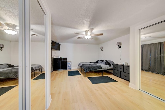 6231 Westport Dr, Port Richey, FL 34668 - bedroom with wood finished floors, a textured ceiling, and a ceiling fan