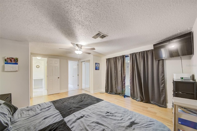 6231 Westport Dr, Port Richey, FL 34668 - bedroom with wood finished floors, a textured ceiling, and ceiling fan