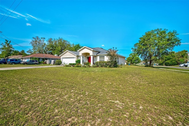 ranch-style home with concrete driveway, a front yard, and a garage