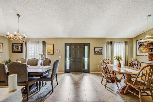 dining space featuring a textured ceiling, plenty of natural light, a chandelier, baseboards, and light tile patterned floors