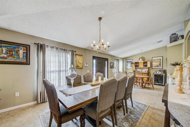 dining space featuring a chandelier, a textured ceiling, light tile patterned floors, lofted ceiling, and baseboards