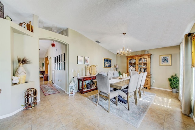 dining room featuring vaulted ceiling, arched walkways, a textured ceiling, a chandelier, and light tile patterned flooring