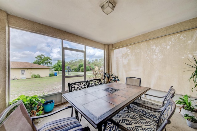 sunroom with outdoor dining space
