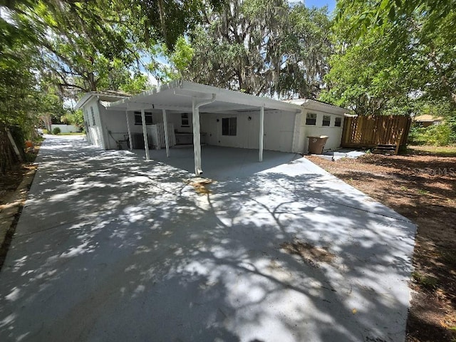 2827 SE 2nd St, Ocala, FL 34471 - view of front facade featuring concrete driveway, a carport, and fence