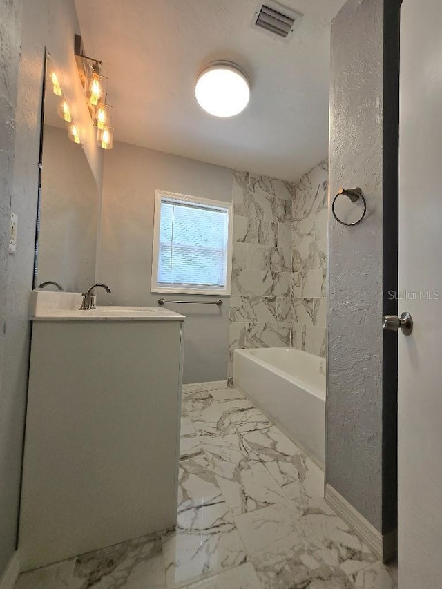 2827 SE 2nd St, Ocala, FL 34471 - full bathroom with a bath, vanity, marble finish floors, and baseboards