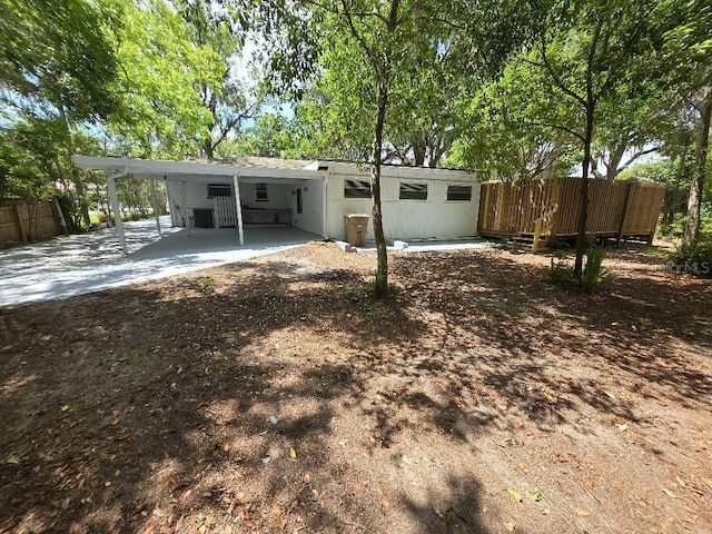2827 SE 2nd St, Ocala, FL 34471 - back of house with an attached carport, fence, and driveway