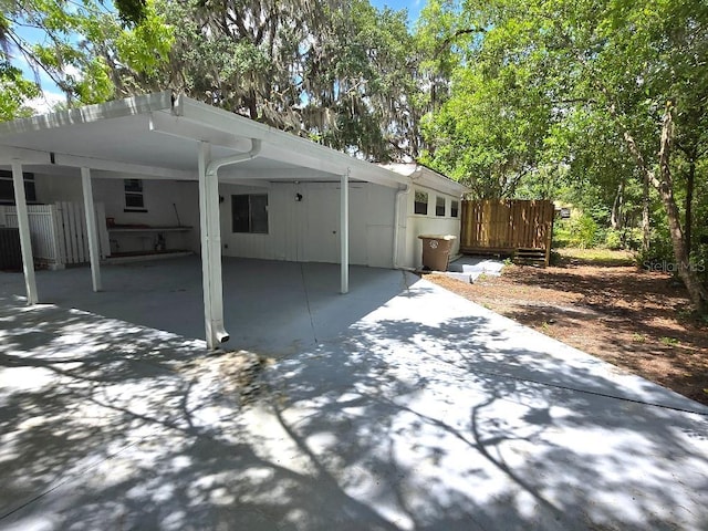2827 SE 2nd St, Ocala, FL 34471 - rear view of house featuring an attached carport, concrete driveway, and fence