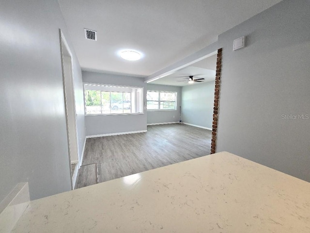 2827 SE 2nd St, Ocala, FL 34471 - empty room featuring wood finished floors, ceiling fan, and baseboards