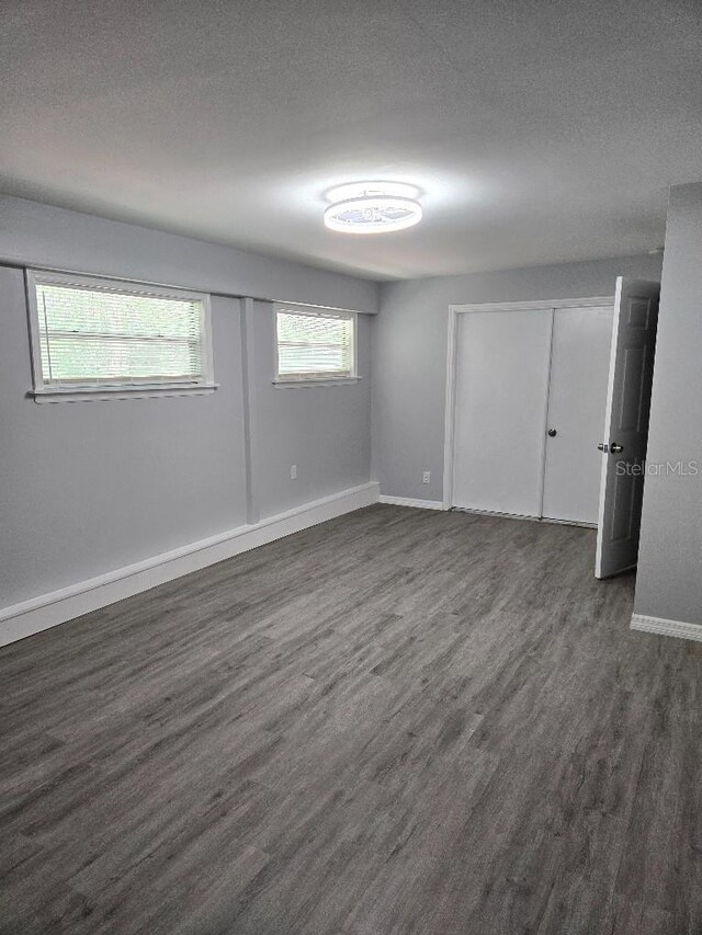 2827 SE 2nd St, Ocala, FL 34471 - empty room featuring baseboards, dark wood-style flooring, and a textured ceiling