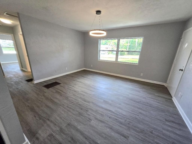 2827 SE 2nd St, Ocala, FL 34471 - spare room featuring healthy amount of natural light, dark wood finished floors, and baseboards