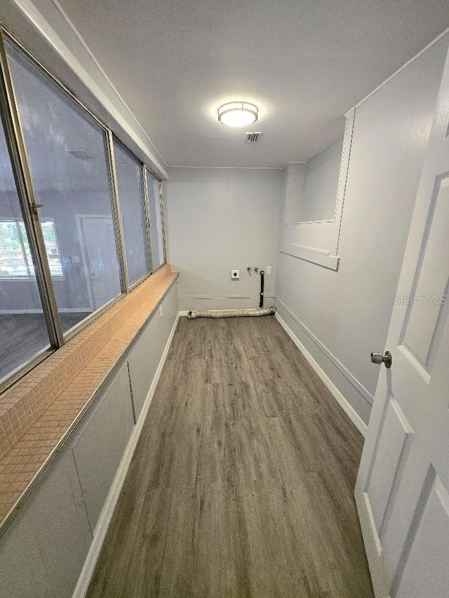 2827 SE 2nd St, Ocala, FL 34471 - clothes washing area with wood finished floors and baseboards