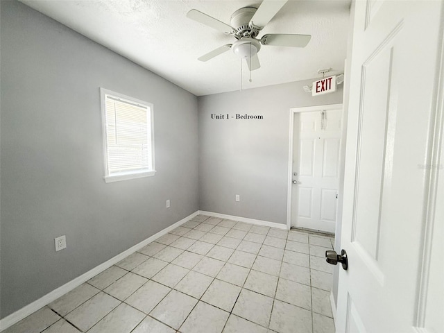 13228 3rd St E, Madeira Beach, FL 33708 - unfurnished room with light tile patterned floors, a ceiling fan, and baseboards