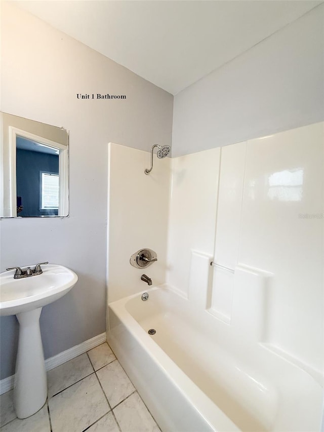 13228 3rd St E, Madeira Beach, FL 33708 - full bath featuring baseboards, tile patterned floors,  shower combination, and a sink
