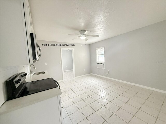 13228 3rd St E, Madeira Beach, FL 33708 - clothes washing area with a sink, ceiling fan, light tile patterned floors, a textured ceiling, and baseboards