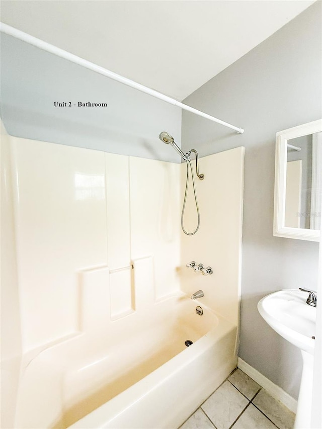 13228 3rd St E, Madeira Beach, FL 33708 - full bathroom with tile patterned flooring, baseboards, and washtub / shower combination