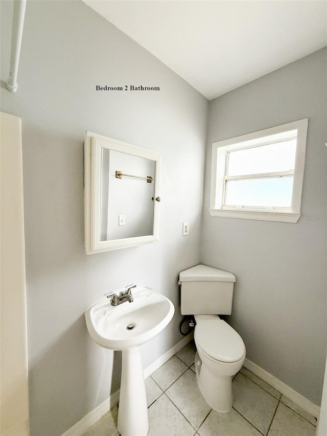 13228 3rd St E, Madeira Beach, FL 33708 - half bathroom with toilet, baseboards, and tile patterned floors