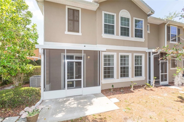 8409 Blue Rock Dr, New Port Richey, FL 34653 - rear view of house featuring stucco siding, central AC, and a patio