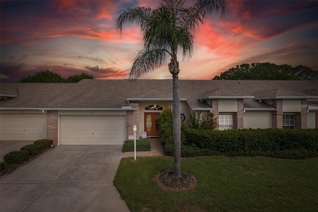 1105 Flora Vista St, New Port Richey, FL 34655 - view of front of house featuring brick siding, a garage, driveway, a front yard, and a shingled roof