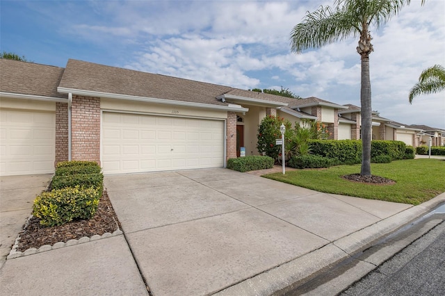 1105 Flora Vista St, New Port Richey, FL 34655 - view of front facade with brick siding, driveway, a front yard, a garage, and roof with shingles
