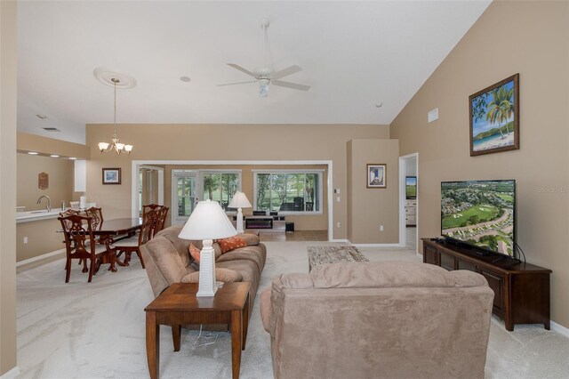 1105 Flora Vista St, New Port Richey, FL 34655 - living area featuring light colored carpet, baseboards, ceiling fan, high vaulted ceiling, and a chandelier