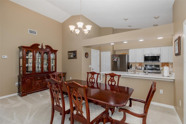 1105 Flora Vista St, New Port Richey, FL 34655 - dining area featuring light colored carpet, lofted ceiling, a chandelier, baseboards, and recessed lighting