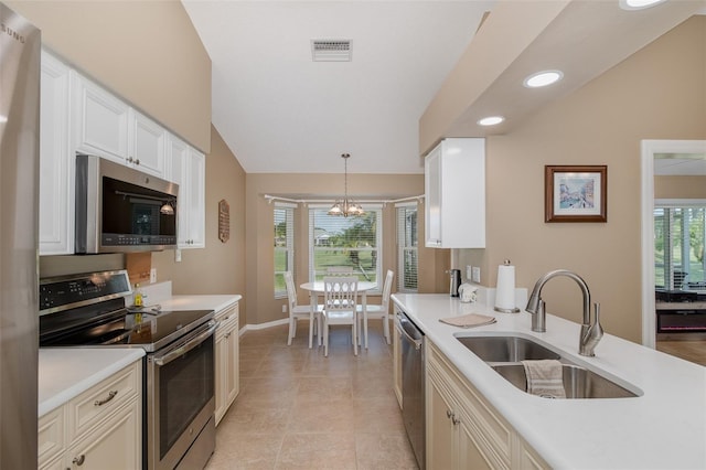 1105 Flora Vista St, New Port Richey, FL 34655 - kitchen featuring stainless steel appliances, a sink, lofted ceiling, a chandelier, and light countertops