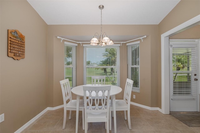 1105 Flora Vista St, New Port Richey, FL 34655 - dining room with a chandelier, light tile patterned floors, and baseboards