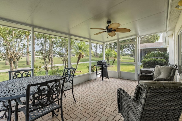 1105 Flora Vista St, New Port Richey, FL 34655 - sunroom featuring a ceiling fan, view of golf course, and plenty of natural light